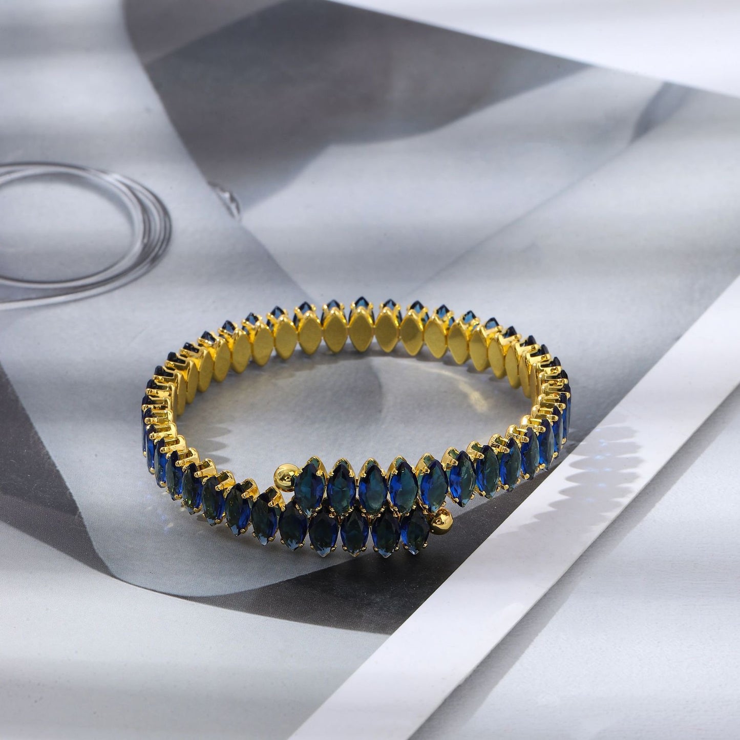 Zoya Bangle Blue — 18K gold plated stainless steel blue crystal cuff by Glitze Accessories Pakistan