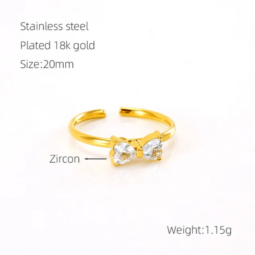 Glitze Accessories Seraphic Bow Ring featuring a delicate bow design and sparkling gemstone accents on a silver band.
