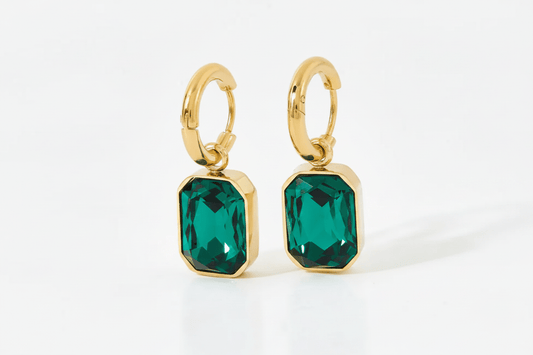 Green Gemma Earrings by Glitze Accessories featuring sparkling green gemstones and delicate gold-tone hooks.