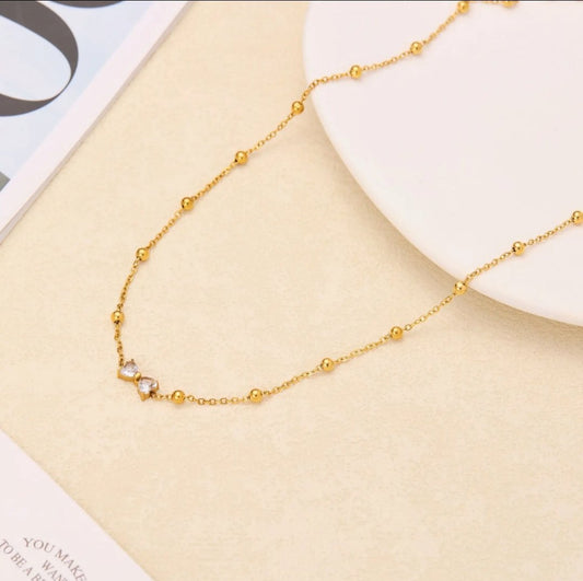 Seraphic Bow Necklace — 18K gold plated stainless steel bow necklace by Glitze Accessories Pakistan