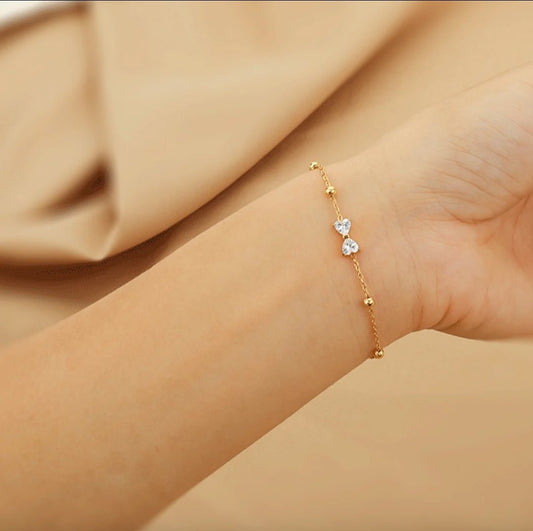 Seraphic Bow Bracelet close-up — waterproof hypoallergenic gold bracelet | Glitze Accessories