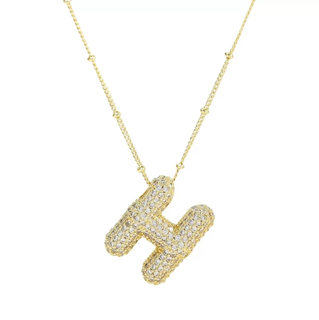 Simple initial necklace with the letter H from Glitze Accessories featuring a delicate chain and minimalist design.