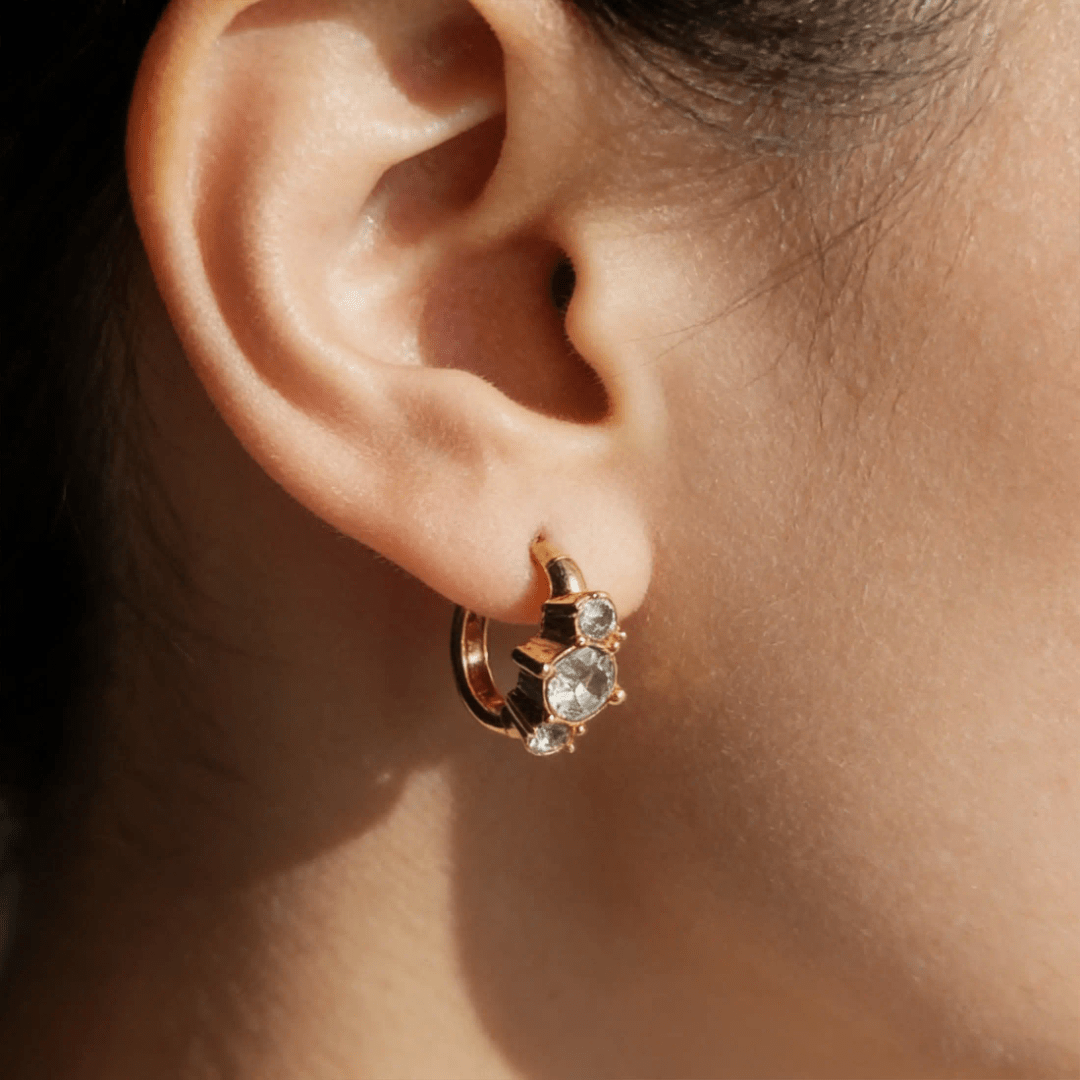 Glitze Accessories Dew jewelry piece with sparkling accents, showcasing elegant design and intricate detailing on a neutral background.