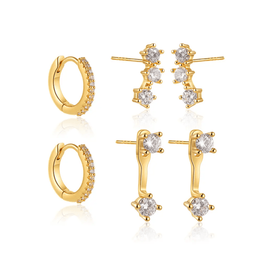Glitze Accessories Clara Stack jewelry set featuring layered gold-toned necklaces and matching earrings on a display.