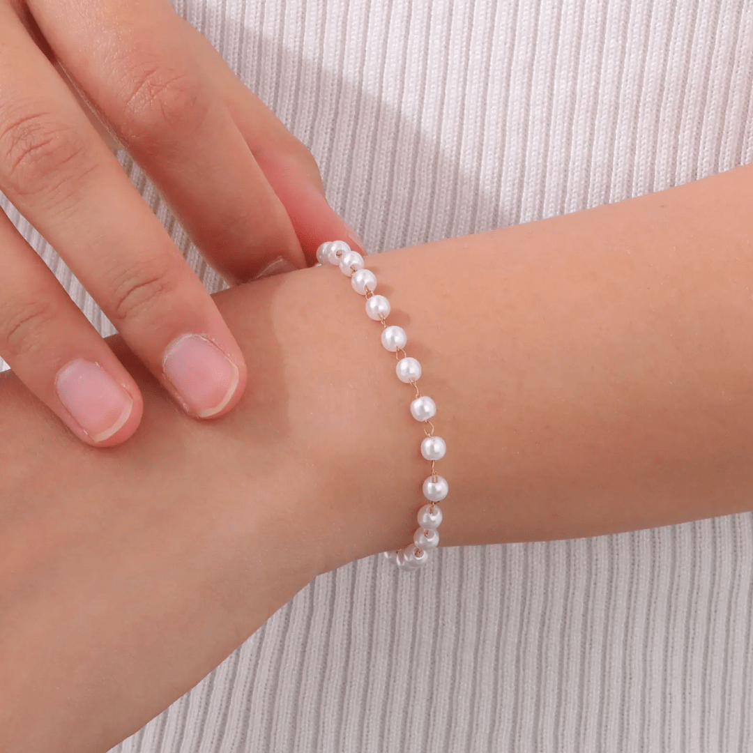 Elegant pearl bracelet by Glitze Accessories featuring white pearls and a delicate clasp on a soft background.