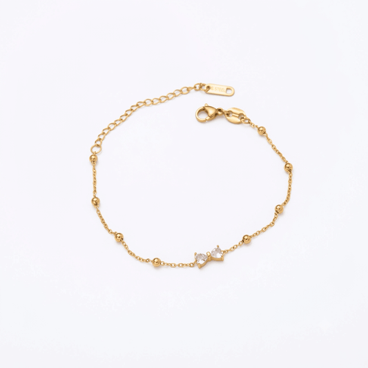Simple silver Seraphic Bow Anklet by Glitze Accessories featuring delicate bow charm on a thin chain.