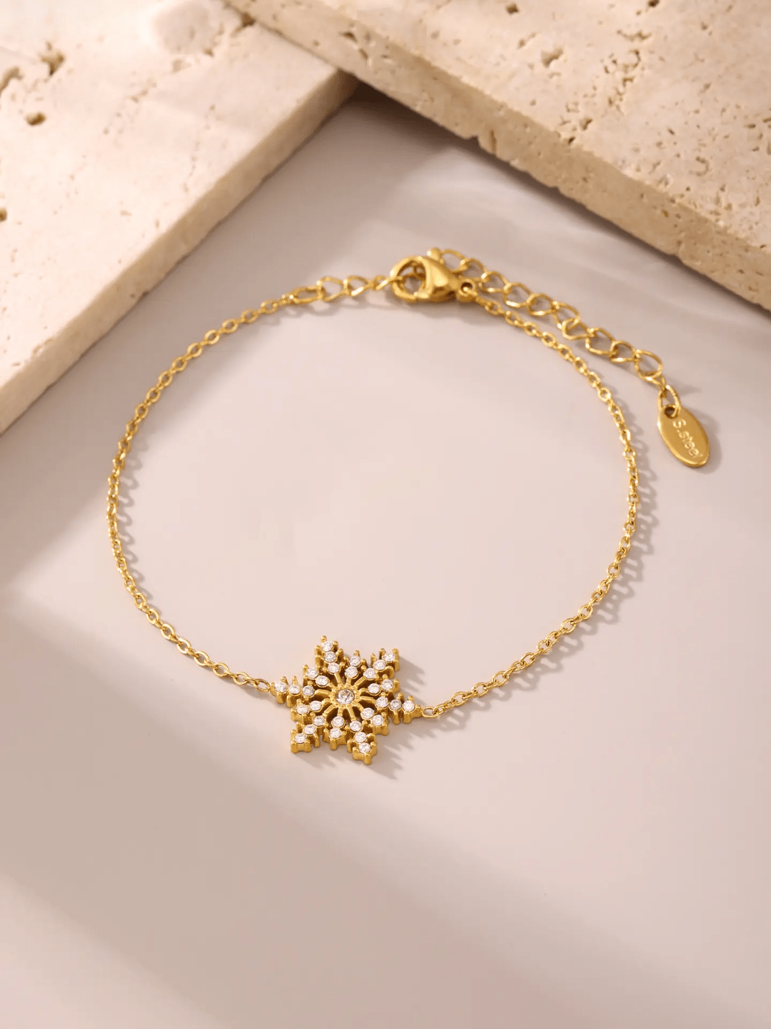 Silver Snowflake Bracelet by Glitze Accessories featuring a delicate snowflake charm on a sleek chain.
