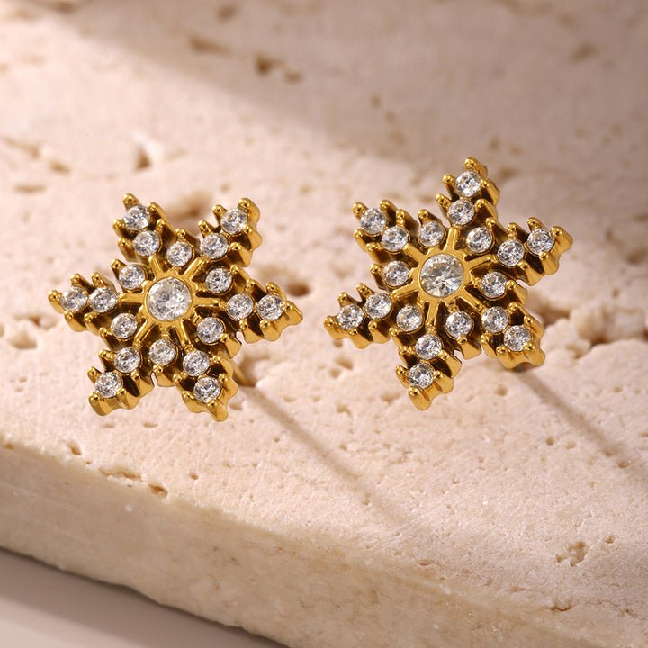 Silver snowflake earrings by Glitze Accessories featuring intricate snowflake designs on elegant dangle hooks.