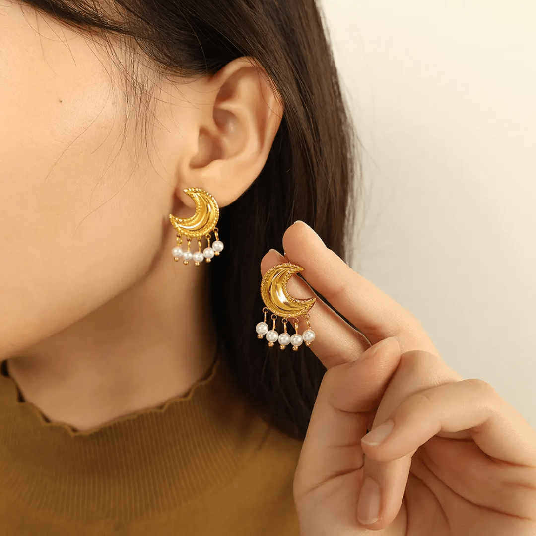 Glitze Accessories Crescent jewelry piece with shiny silver finish and intricate design on a white background.