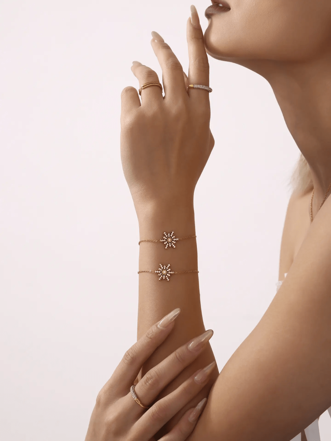 Silver Snowflake Bracelet by Glitze Accessories featuring delicate snowflake charms on a sleek chain.