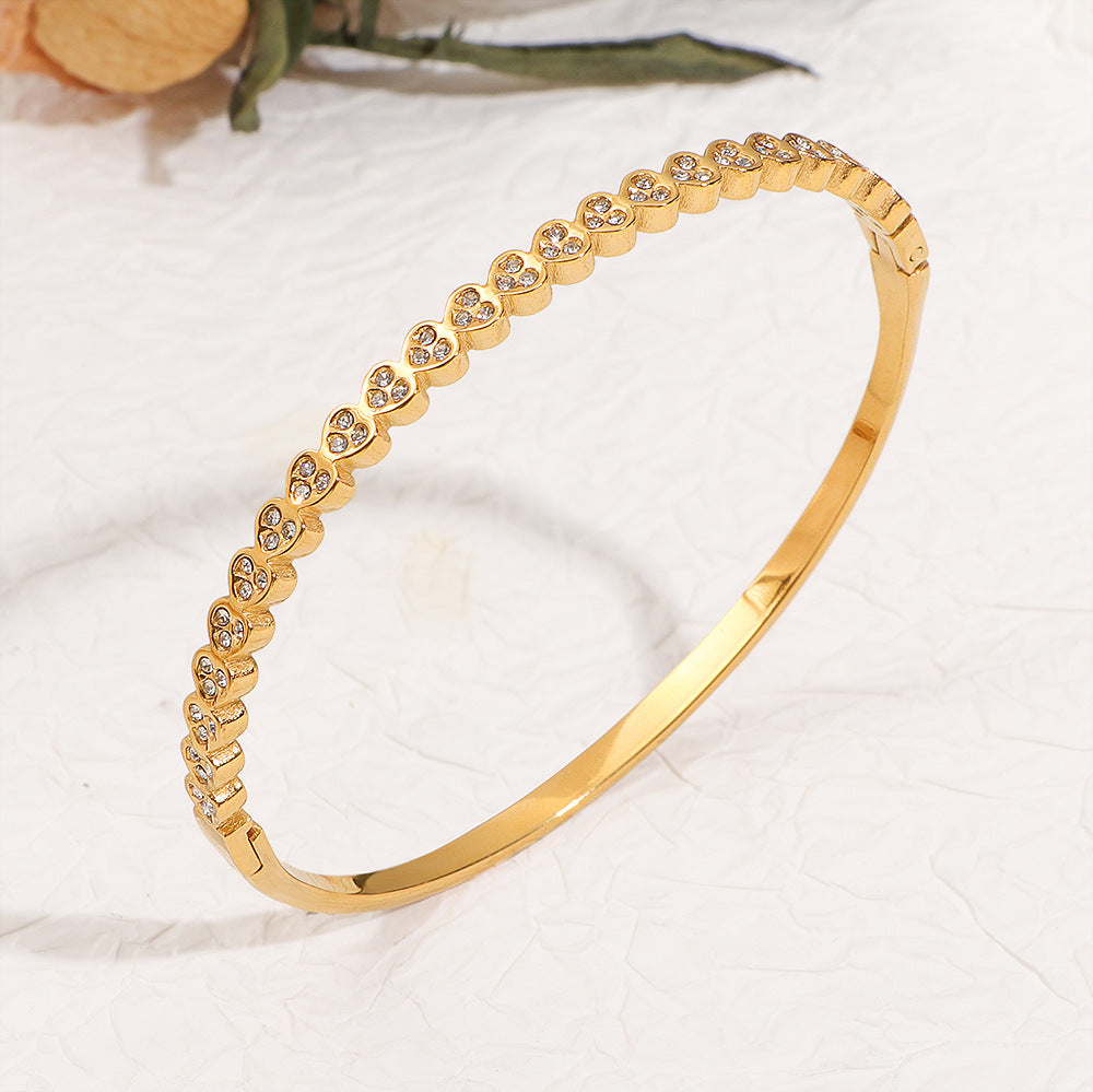 Adora Bangle detail – slim hinged stainless steel bangle with crystal hearts by Glitze Accessories