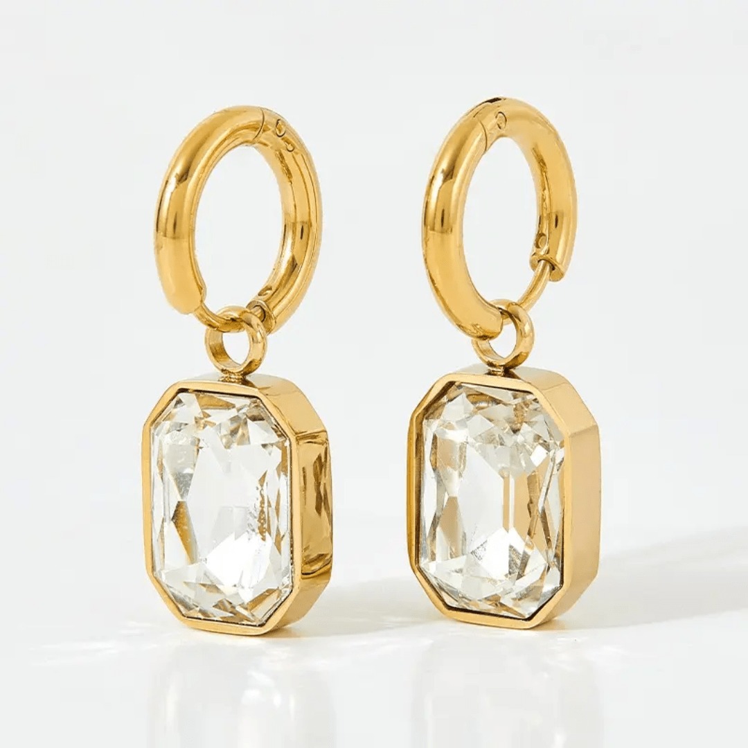 White Gemma Earrings by Glitze Accessories featuring elegant, sparkling gemstone design and silver-tone hooks.