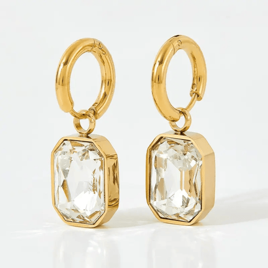 White Gemma Earrings by Glitze Accessories featuring elegant, sparkling gemstone design and silver-tone hooks.
