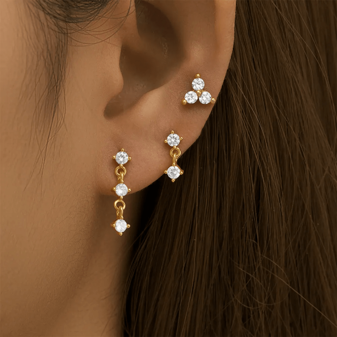 Glitze Accessories Mina Stack jewelry set featuring layered gold-tone necklaces and matching earrings on a white background.
