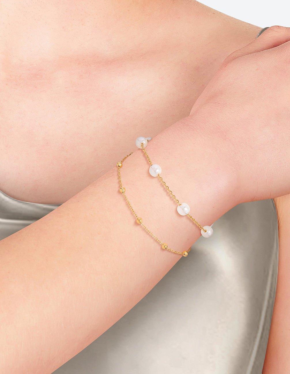 Raine jewelry by Glitze Accessories featuring a delicate chain with a stylish pendant, styled against a neutral background.