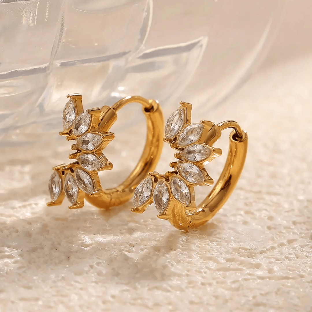 Glitze Accessories Allure Earrings featuring elegant gold-toned hoops with intricate detailing and sparkling accents.